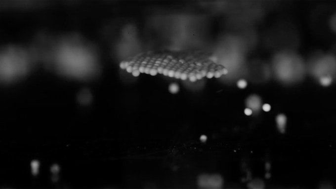 a group of plastic beads hovering in midair