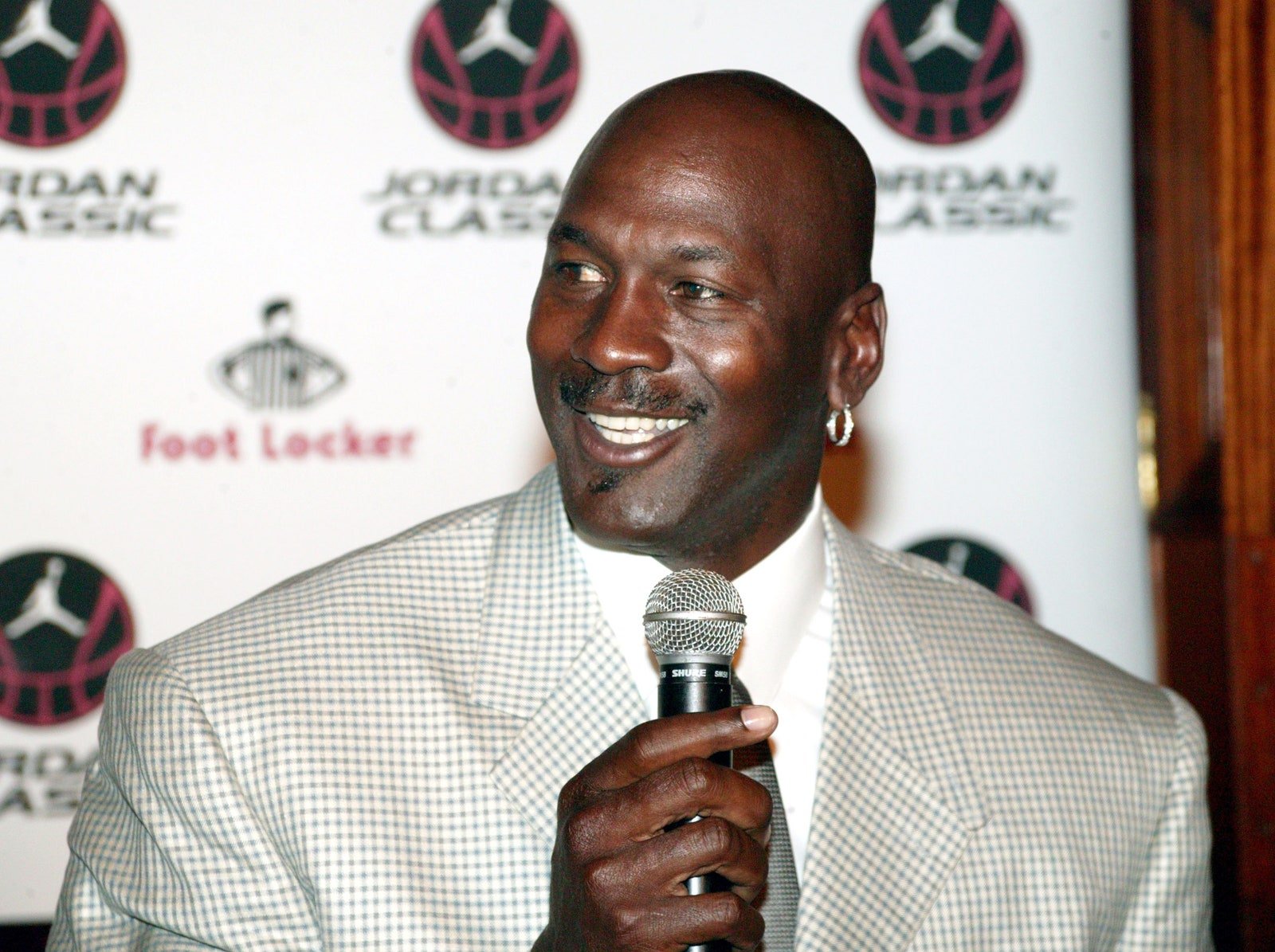 Image may contain Michael Jordan Electrical Device Microphone Adult Person Crowd Head People and Face